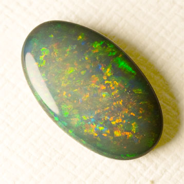 Black Opal 2.94 ct dark green studded with yellow red and orange
