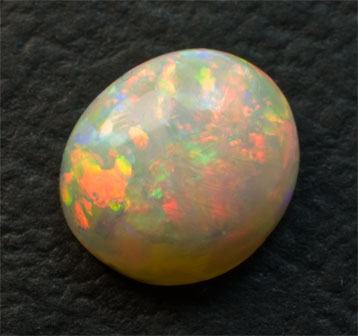 Very Colorful Milky Opal 1.6 carats domed red, yellow, green, and indigo blue